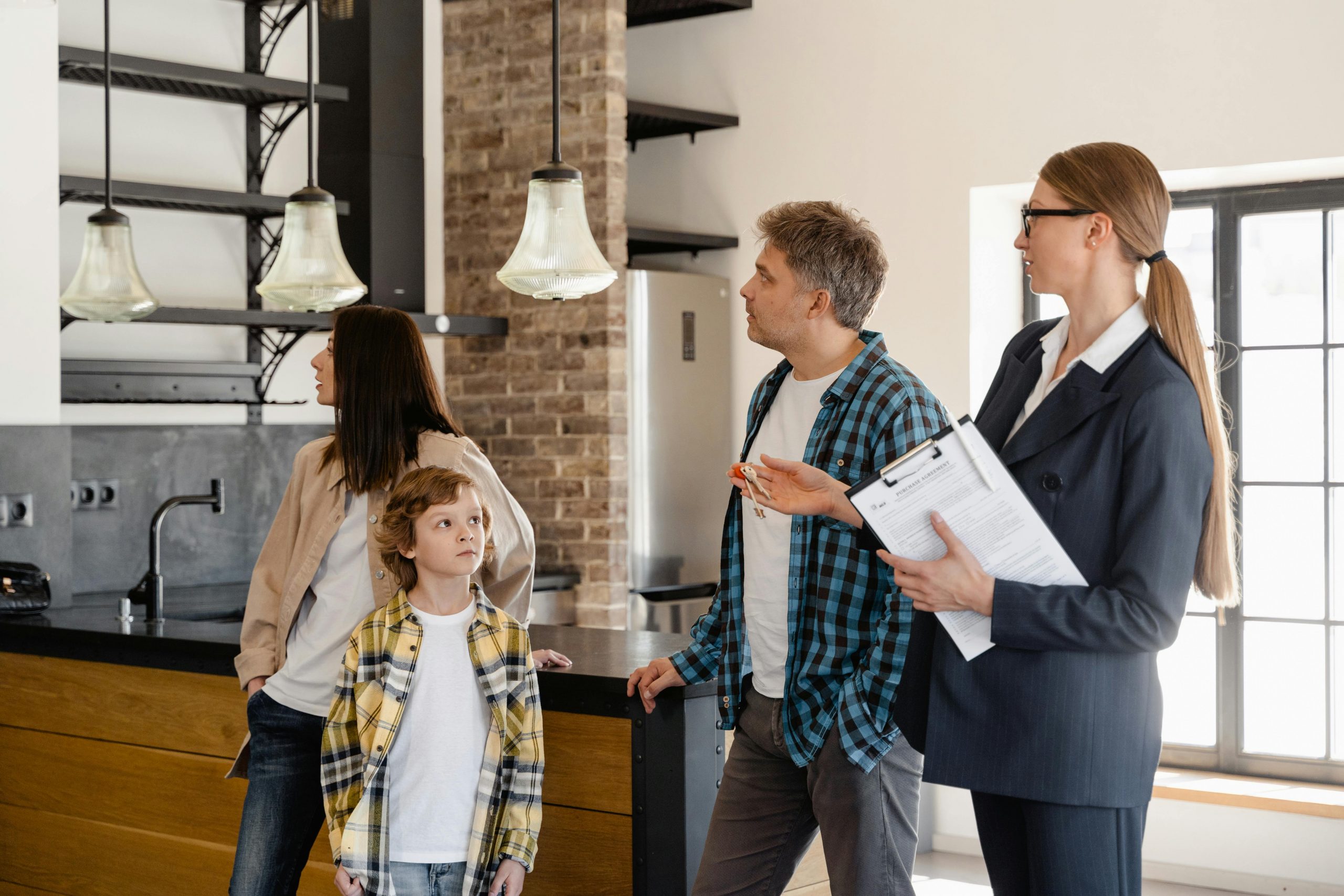 A family walking through a home with a Realtor.